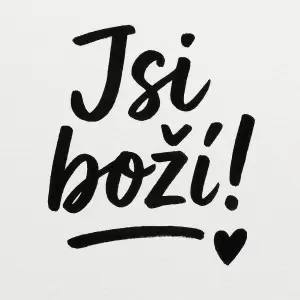 Nápis, který je psaný ručně štětcem Jsi boží ! a za vykřičníkem černé malé srdíčko