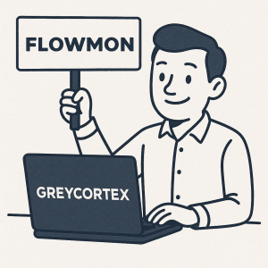 panaček který drží v ruce ceduli s napisem FLOWMON ale ma před sebou PC a na něm je Greycortex nápis