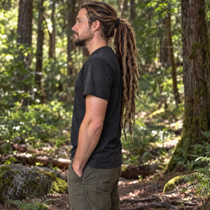 He has his dreadlocks in a ponytail. He's in the forest. Made his dreadlocks REALLY look like like dreadlocks
